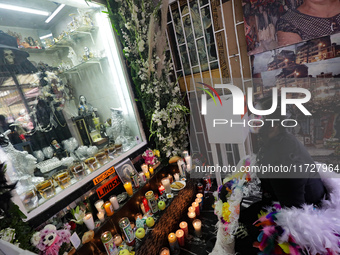 A devotee disguised as a catrina prays in front of Santa Muerte's altar in the Tepito neighborhood to show devotion and give thanks for favo...