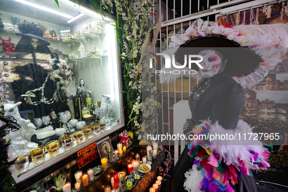 A devotee disguised as a catrina prays in front of Santa Muerte's altar in the Tepito neighborhood to show devotion and give thanks for favo...