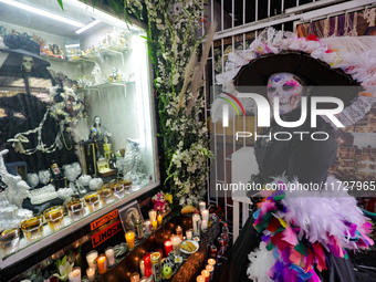 A devotee disguised as a catrina prays in front of Santa Muerte's altar in the Tepito neighborhood to show devotion and give thanks for favo...