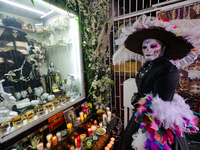 A devotee disguised as a catrina prays in front of Santa Muerte's altar in the Tepito neighborhood to show devotion and give thanks for favo...