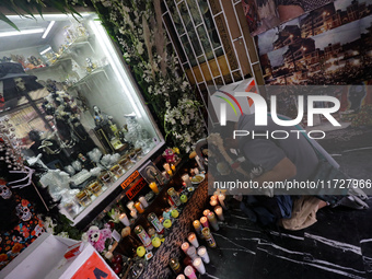 A devotee prays in front of Santa Muerte's altar in the Tepito neighborhood to show devotion and give thanks for favors granted. Believers o...