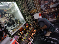 A devotee prays in front of Santa Muerte's altar in the Tepito neighborhood to show devotion and give thanks for favors granted. Believers o...