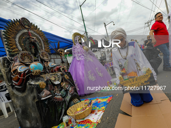 A devotee visits the Altar of Santa Muerte on his knees on Alfareria Street in the Tepito neighborhood to show devotion and give thanks for...