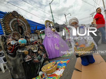 A devotee visits the Altar of Santa Muerte on his knees on Alfareria Street in the Tepito neighborhood to show devotion and give thanks for...