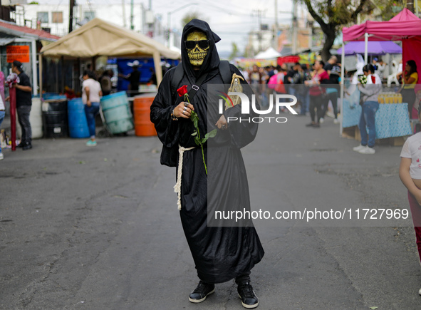 A devotee visits the altar of Santa Muerte located on Alfareria Street in the Tepito neighborhood to show their devotion and give thanks for...