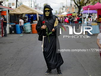 A devotee visits the altar of Santa Muerte located on Alfareria Street in the Tepito neighborhood to show their devotion and give thanks for...