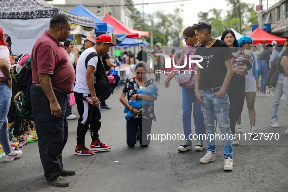 A devotee visits the Altar of Santa Muerte on his knees on Alfareria Street in the Tepito neighborhood to show devotion and give thanks for...