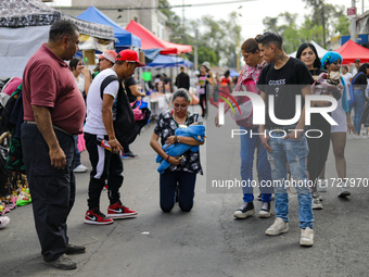 A devotee visits the Altar of Santa Muerte on his knees on Alfareria Street in the Tepito neighborhood to show devotion and give thanks for...