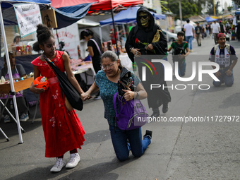 A devotee visits the Altar of Santa Muerte on his knees on Alfareria Street in the Tepito neighborhood to show devotion and give thanks for...