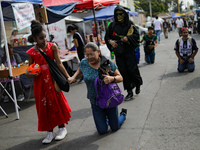 A devotee visits the Altar of Santa Muerte on his knees on Alfareria Street in the Tepito neighborhood to show devotion and give thanks for...