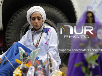 A devotee visits the altar of Santa Muerte located on Alfareria Street in the Tepito neighborhood to show their devotion and give thanks for...