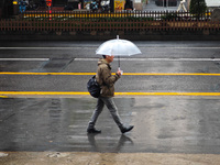 Pedestrians hold umbrellas as they walk on a street in Shanghai, China, on November 1, 2024. (