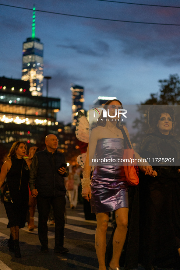 Costumed parade goers march during the 51st Annual Village Halloween Parade in New York, NY, on October 31, 2024. 