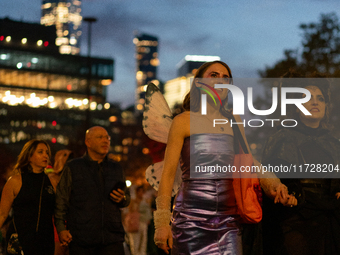 Costumed parade goers march during the 51st Annual Village Halloween Parade in New York, NY, on October 31, 2024. (