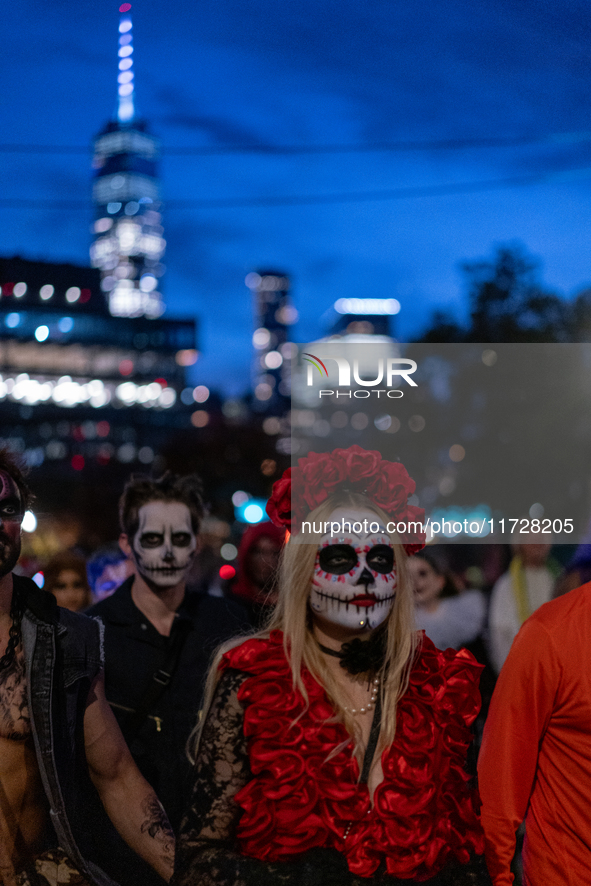 Costumed parade goers march during the 51st Annual Village Halloween Parade in New York, NY, on October 31, 2024. 