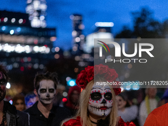 Costumed parade goers march during the 51st Annual Village Halloween Parade in New York, NY, on October 31, 2024. (