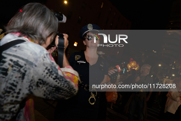 Costumed parade goers pose for photos during the 51st Annual Village Halloween Parade in New York, NY, on October 31, 2024. 