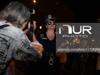 Costumed parade goers pose for photos during the 51st Annual Village Halloween Parade in New York, NY, on October 31, 2024. (