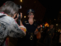 Costumed parade goers pose for photos during the 51st Annual Village Halloween Parade in New York, NY, on October 31, 2024. (