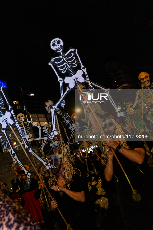 Costumed parade goers celebrate during the 51st Annual Village Halloween Parade in New York, NY, on October 31, 2024. 