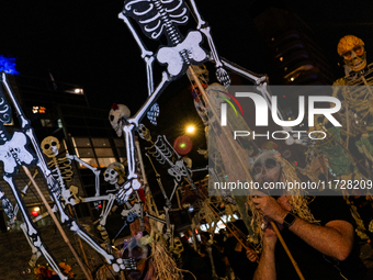 Costumed parade goers celebrate during the 51st Annual Village Halloween Parade in New York, NY, on October 31, 2024. (