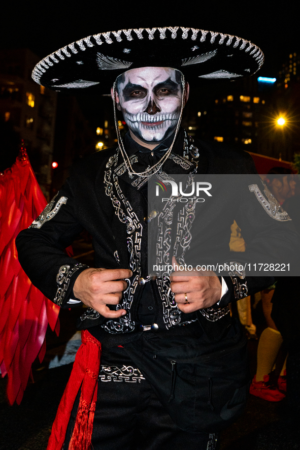 Costumed parade goers celebrate during the 51st Annual Village Halloween Parade in New York, NY, on October 31, 2024. 