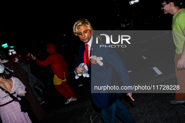 Costumed parade goers celebrate during the 51st Annual Village Halloween Parade in New York, NY, on October 31, 2024. 