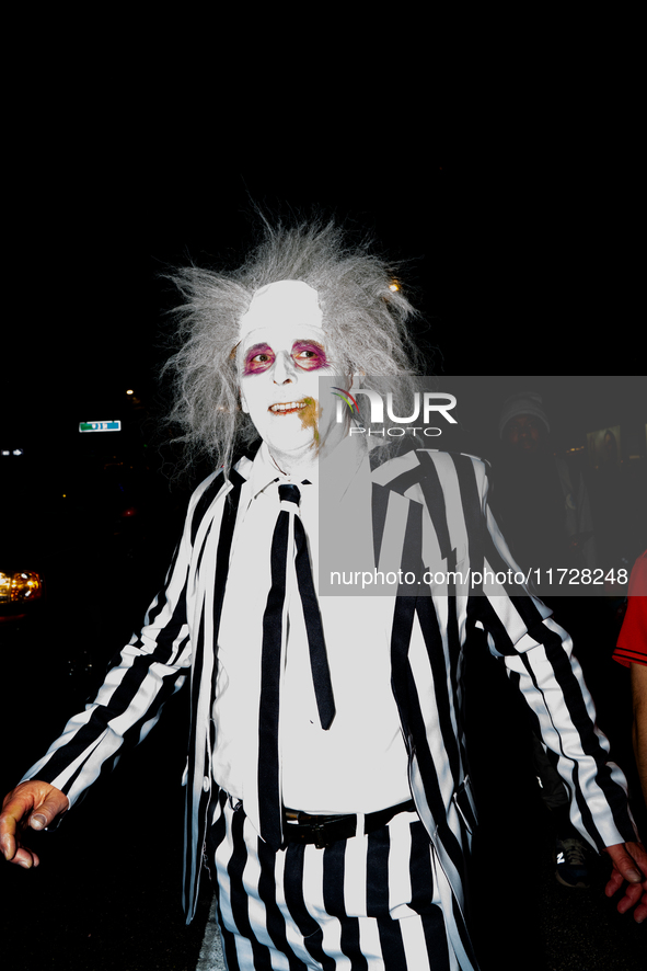 Costumed parade goers march during the 51st Annual Village Halloween Parade in New York, NY, on October 31, 2024. 