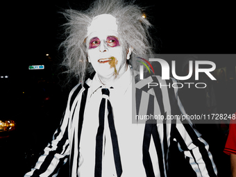 Costumed parade goers march during the 51st Annual Village Halloween Parade in New York, NY, on October 31, 2024. (