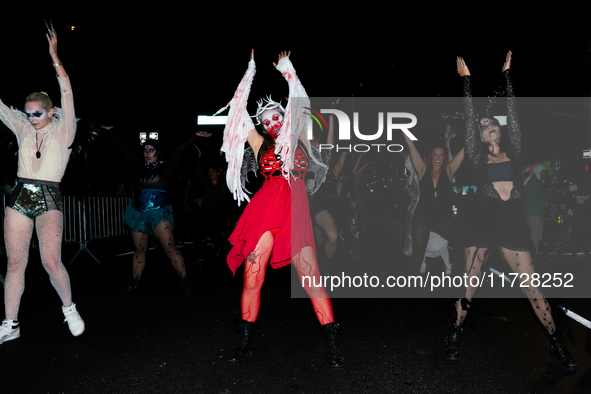 Costumed parade goers dance during the 51st Annual Village Halloween Parade in New York, NY, on October 31, 2024. 