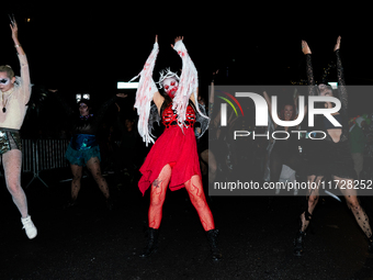 Costumed parade goers dance during the 51st Annual Village Halloween Parade in New York, NY, on October 31, 2024. (