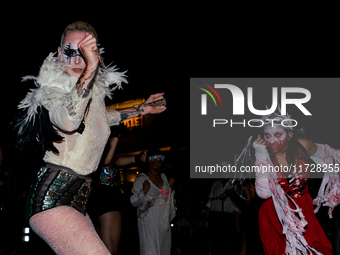 Costumed parade goers dance during the 51st Annual Village Halloween Parade in New York, NY, on October 31, 2024. (