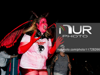 Costumed parade goers dance during the 51st Annual Village Halloween Parade in New York, NY, on October 31, 2024. (