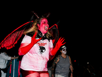 Costumed parade goers dance during the 51st Annual Village Halloween Parade in New York, NY, on October 31, 2024. (