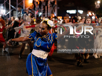 Costumed parade goers dance during the 51st Annual Village Halloween Parade in New York, NY, on October 31, 2024. (