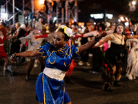 Costumed parade goers dance during the 51st Annual Village Halloween Parade in New York, NY, on October 31, 2024. (