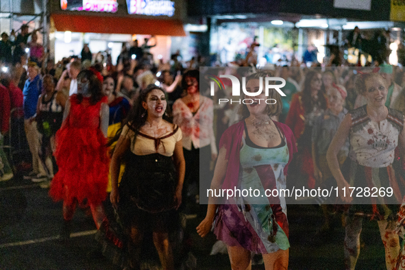 Costumed parade goers dance during the 51st Annual Village Halloween Parade in New York, NY, on October 31, 2024. 