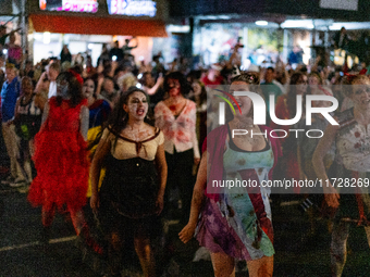 Costumed parade goers dance during the 51st Annual Village Halloween Parade in New York, NY, on October 31, 2024. (