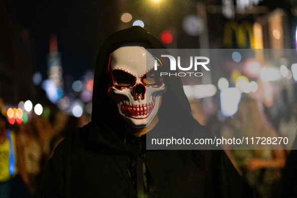 Costumed parade goers celebrate during the 51st Annual Village Halloween Parade in New York, NY, on October 31, 2024. 