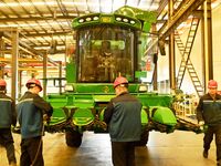 Construction workers assemble agricultural machinery at Jiufang Taihe International Heavy Industries (Qingdao) Co., LTD., Hongshiya Street,...