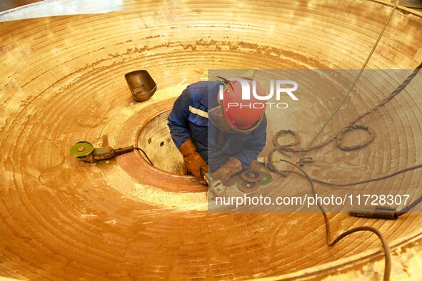 A construction worker builds petrochemical equipment parts at Lanshi Heavy Machinery Co., LTD., Hongshiya Street, in Qingdao, China, on Octo...