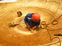 A construction worker builds petrochemical equipment parts at Lanshi Heavy Machinery Co., LTD., Hongshiya Street, in Qingdao, China, on Octo...