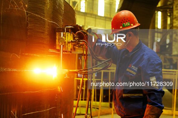 A construction worker builds petrochemical equipment parts at Lanshi Heavy Machinery Co., LTD., Hongshiya Street, in Qingdao, China, on Octo...