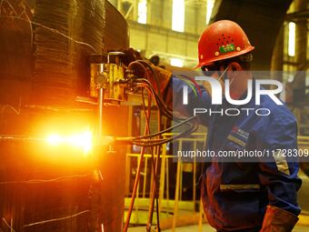 A construction worker builds petrochemical equipment parts at Lanshi Heavy Machinery Co., LTD., Hongshiya Street, in Qingdao, China, on Octo...