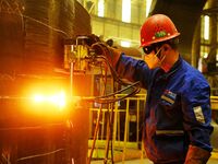 A construction worker builds petrochemical equipment parts at Lanshi Heavy Machinery Co., LTD., Hongshiya Street, in Qingdao, China, on Octo...