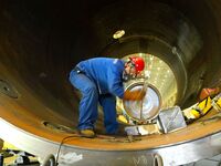 A construction worker builds petrochemical equipment parts at Lanshi Heavy Machinery Co., LTD., Hongshiya Street, in Qingdao, China, on Octo...