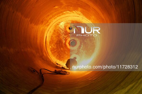 A construction worker builds petrochemical equipment parts at Lanshi Heavy Machinery Co., LTD., Hongshiya Street, in Qingdao, China, on Octo...