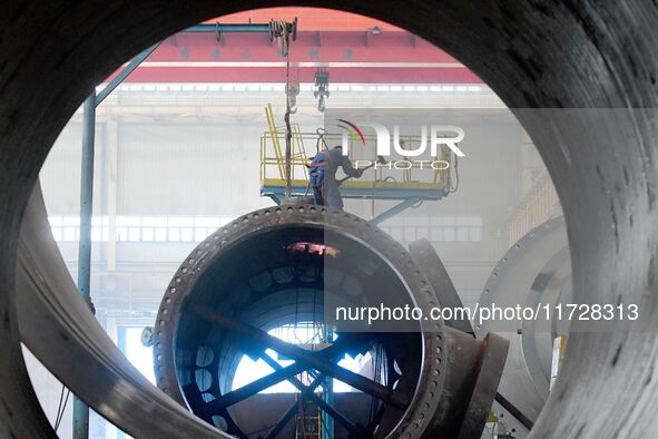 A construction worker builds petrochemical equipment parts at Lanshi Heavy Machinery Co., LTD., Hongshiya Street, in Qingdao, China, on Octo...