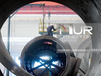 A construction worker builds petrochemical equipment parts at Lanshi Heavy Machinery Co., LTD., Hongshiya Street, in Qingdao, China, on Octo...