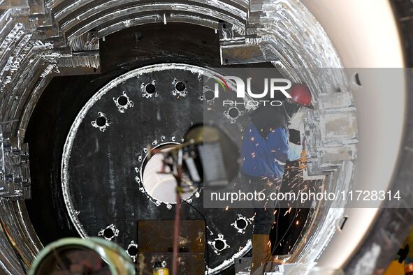 A construction worker builds petrochemical equipment parts at Lanshi Heavy Machinery Co., LTD., Hongshiya Street, in Qingdao, China, on Octo...